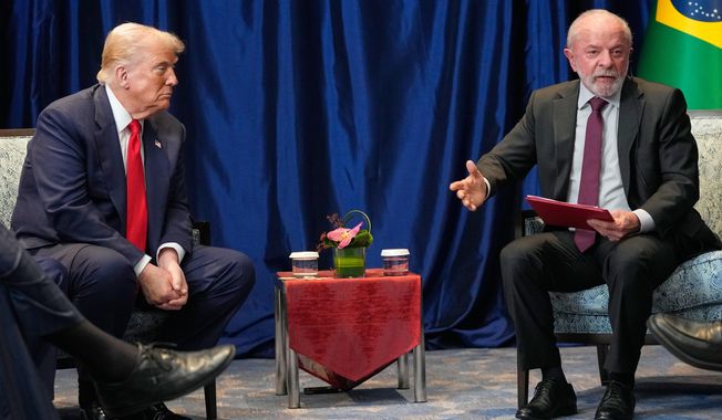 President Donald Trump meets with Brazil's President Luiz Inacio Lula da Silva on the sidelines of the ASEAN Summit in Kuala Lumpur, Malaysia, Sunday, Oct. 26, 2025. (AP Photo/Mark Schiefelbein)