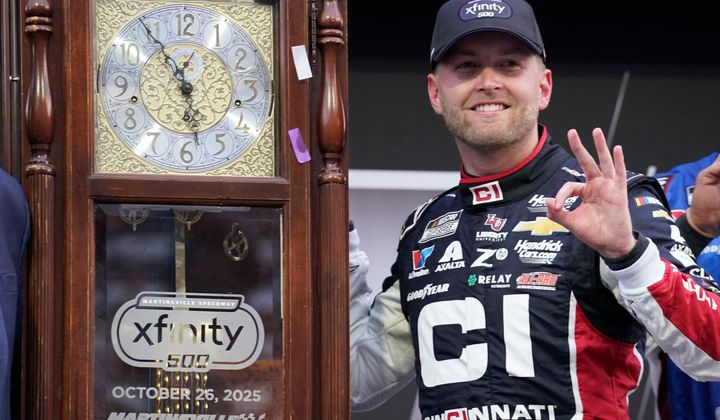 William Byron poses with the trophy in Victory Lane after winning a NASCAR Cup series auto race in Martinsville, Va., Sunday, Oct. 26, 2025. (AP Photo/Chuck Burton)
