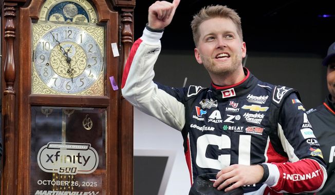 William Byron celebrates in Victory Lane after winning a NASCAR Cup series auto race in Martinsville, Va., Sunday, Oct. 26, 2025. (AP Photo/Chuck Burton)
