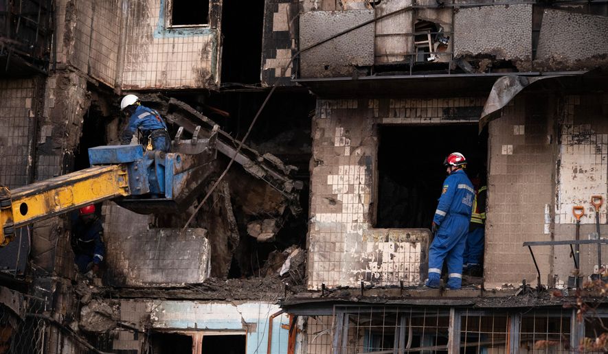 Firefighters work at a destroyed apartment building after a Russian drone attack in Kyiv, Ukraine, Sunday, Oct. 26, 2025. (AP Photo/Dan Bashakov)