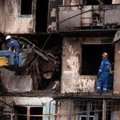 Firefighters work at a destroyed apartment building after a Russian drone attack in Kyiv, Ukraine, Sunday, Oct. 26, 2025. (AP Photo/Dan Bashakov)