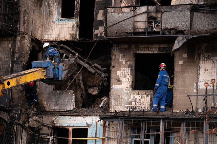Firefighters work at a destroyed apartment building after a Russian drone attack in Kyiv, Ukraine, Sunday, Oct. 26, 2025. (AP Photo/Dan Bashakov)