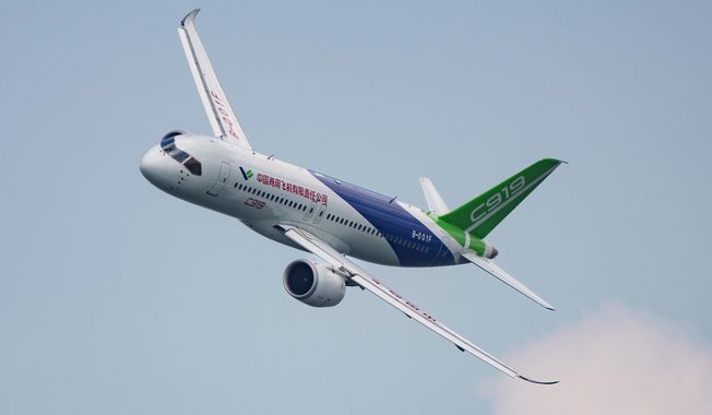 FILE - A COMAC C919 aircraft flies during the first day of the Singapore Airshow in Singapore, Feb. 20, 2024. (AP Photo/Vincent Thian, File)