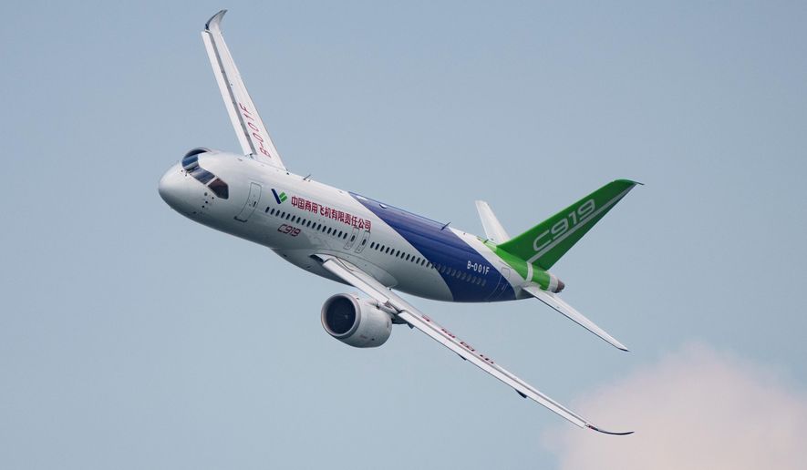 FILE - A COMAC C919 aircraft flies during the first day of the Singapore Airshow in Singapore, Feb. 20, 2024. (AP Photo/Vincent Thian, File)