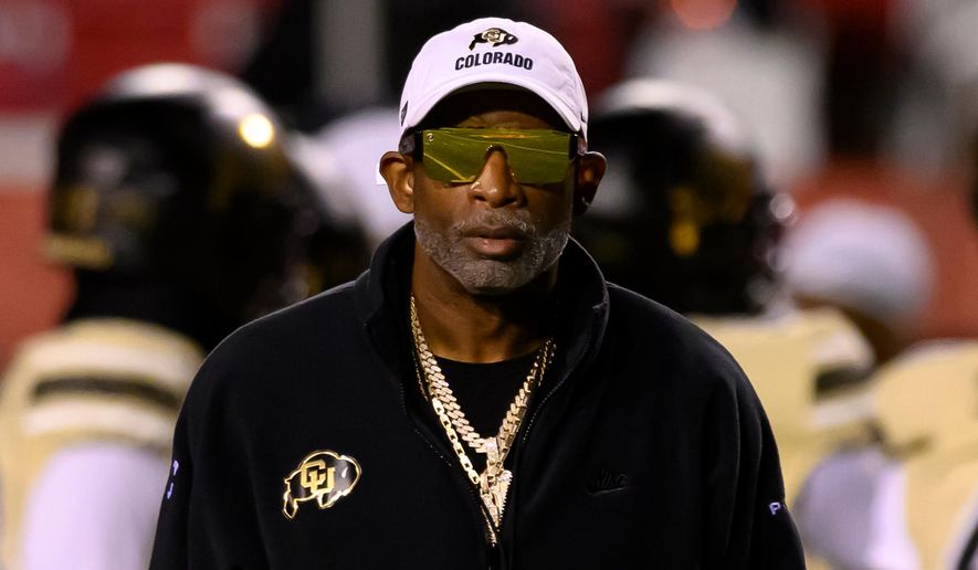 Colorado head coach Deion Sanders watches his players warm up before an NCAA college football game against Utah, Saturday, Oct. 25, 2025, in Salt Lake City, Utah. (AP Photo/Tyler Tate)