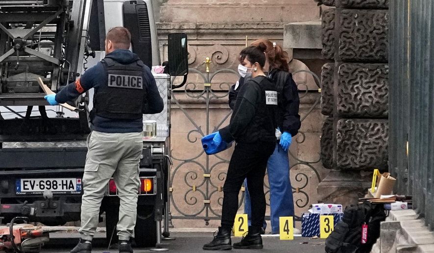 Police officers look for clues by a basket lift used by thieves Sunday, Oct. 19, 2025 at the Louvre museum in Paris. (AP Photo/Thibault Camus)