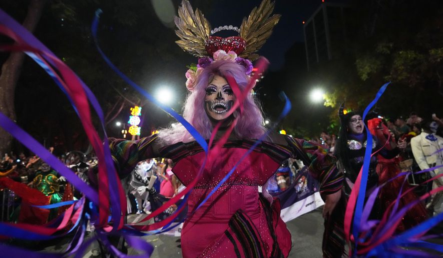 Drag artist Angel Arumir takes part in the annual Day of the Dead Catrina parade in Mexico City, Sunday, Oct. 26, 2025. (AP Photo/Claudia Rosel)