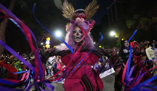 Drag artist Angel Arumir takes part in the annual Day of the Dead Catrina parade in Mexico City, Sunday, Oct. 26, 2025. (AP Photo/Claudia Rosel)