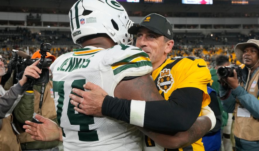 Pittsburgh Steelers' Aaron Rodgers hugs Green Bay Packers' Elgton Jenkins after an NFL football game Sunday, Oct. 26, 2025, in Pittsburgh. (AP Photo/Sue Ogrocki)