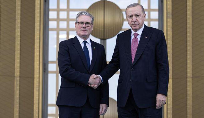 Turkey's President Recep Tayyip Erdogan, right, and Britain's Prime Minister Keir Starmer shakes hands prior to their meeting at the presidential palace, in Ankara, Monday, Oct. 27, 2025. (Ugur Yildirim/Dia Photo via AP)