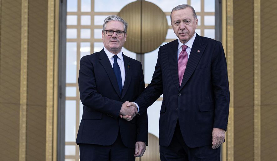 Turkey's President Recep Tayyip Erdogan, right, and Britain's Prime Minister Keir Starmer shakes hands prior to their meeting at the presidential palace, in Ankara, Monday, Oct. 27, 2025. (Ugur Yildirim/Dia Photo via AP)