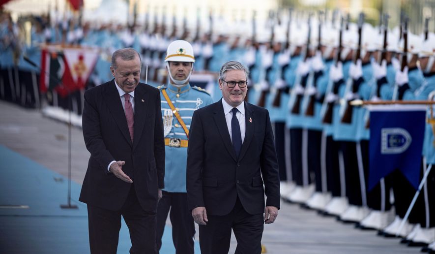 Turkey's President Recep Tayyip Erdogan, left, and Britain's Prime Minister Keir Starmer review an honor guard during a welcome ceremony prior their meeting at the presidential palace, in Ankara, Monday, Oct. 27, 2025. (Ugur Yildirim/Dia Photo via AP)