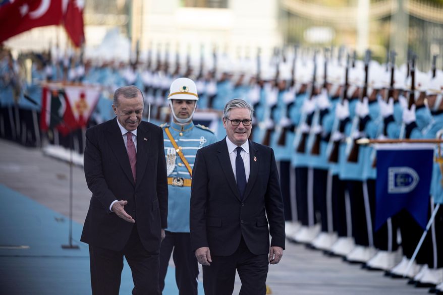 Turkey's President Recep Tayyip Erdogan, left, and Britain's Prime Minister Keir Starmer review an honor guard during a welcome ceremony prior their meeting at the presidential palace, in Ankara, Monday, Oct. 27, 2025. (Ugur Yildirim/Dia Photo via AP)
