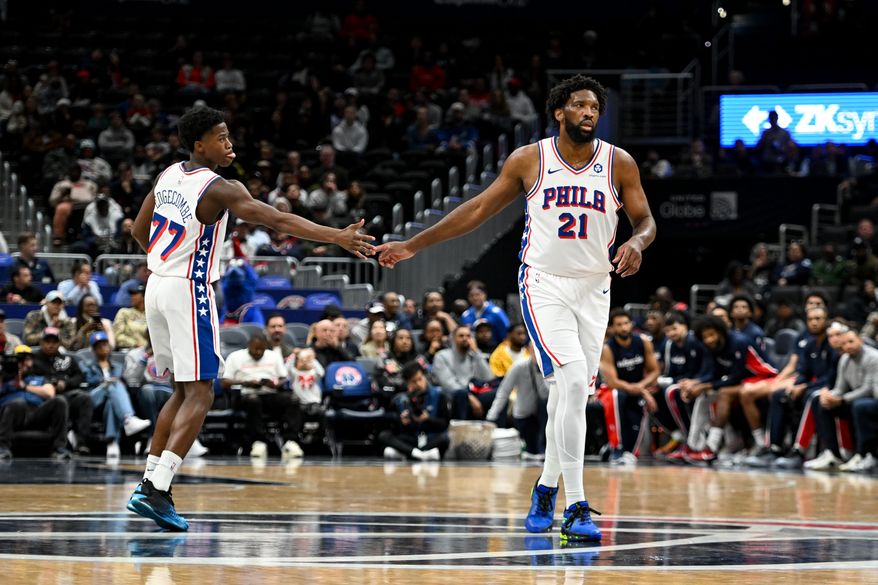 Philadelphia 76ers center Joel Embiid (21) slapping hands with guard VJ Edgecombe (77) after making a shot during the first quarter of an NBA game against the Washington Wizards at Capital One Arena in Washington D.C., October 28, 2025. (Photo for the Washington Times)