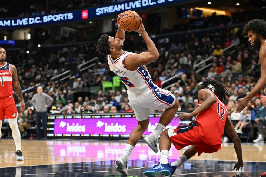 Philadelphia 76ers guard Quentin Grimes (5) putting up a shot while falling down during the first quarter of an NBA game against the Washington Wizards at Capital One Arena in Washington D.C., October 28, 2025. (Photo for the Washington Times)