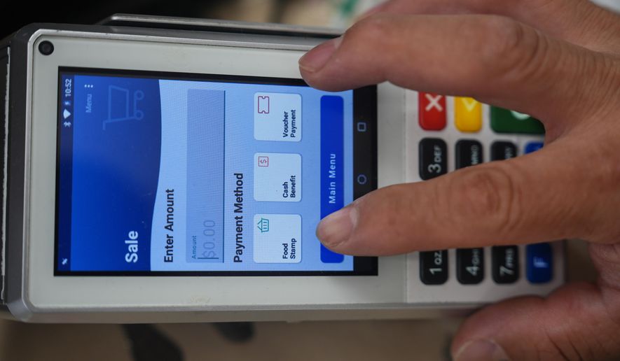 A shopper makes a purchase with food stamps on Monday, Oct. 27, 2025, in Los Angeles. (AP Photo/Damian Dovarganes)
