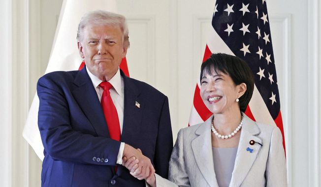President Donald Trump, left, and Japanese Prime Minister Sanae Takaichi shake hands before their summit talk at Akasaka Palace in Tokyo, Tuesday, Oct. 28, 2025. (Kyodo News via AP)