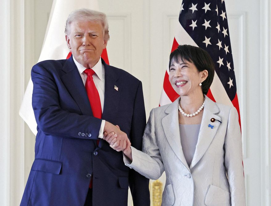 President Donald Trump, left, and Japanese Prime Minister Sanae Takaichi shake hands before their summit talk at Akasaka Palace in Tokyo, Tuesday, Oct. 28, 2025. (Kyodo News via AP)