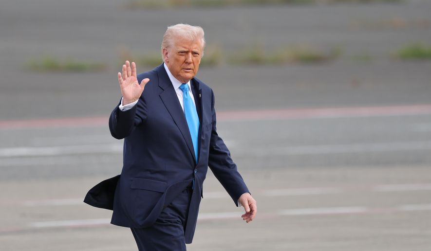 U.S. President Donald Trump walks towards Air Force One at Haneda Airport in Tokyo for his departure to South Korea, Wednesday, Oct. 29, 2025. (Kim Kyung-Hoon/Pool Photo via AP)