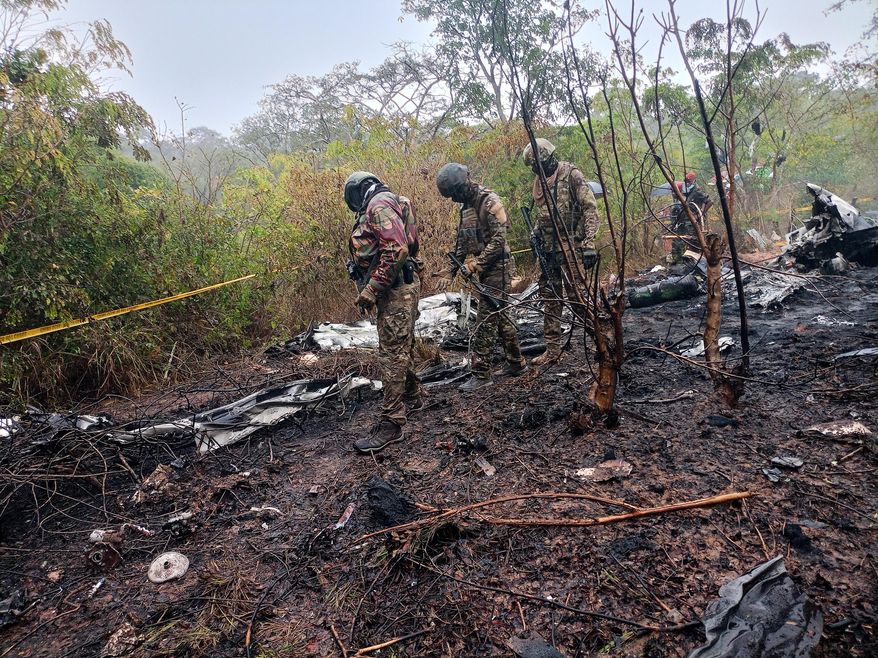 Kenyan officials inspect the scene of a plane crash near Diani, Kenya, Tuesday, Oct. 28, 2025. (AP Photo)