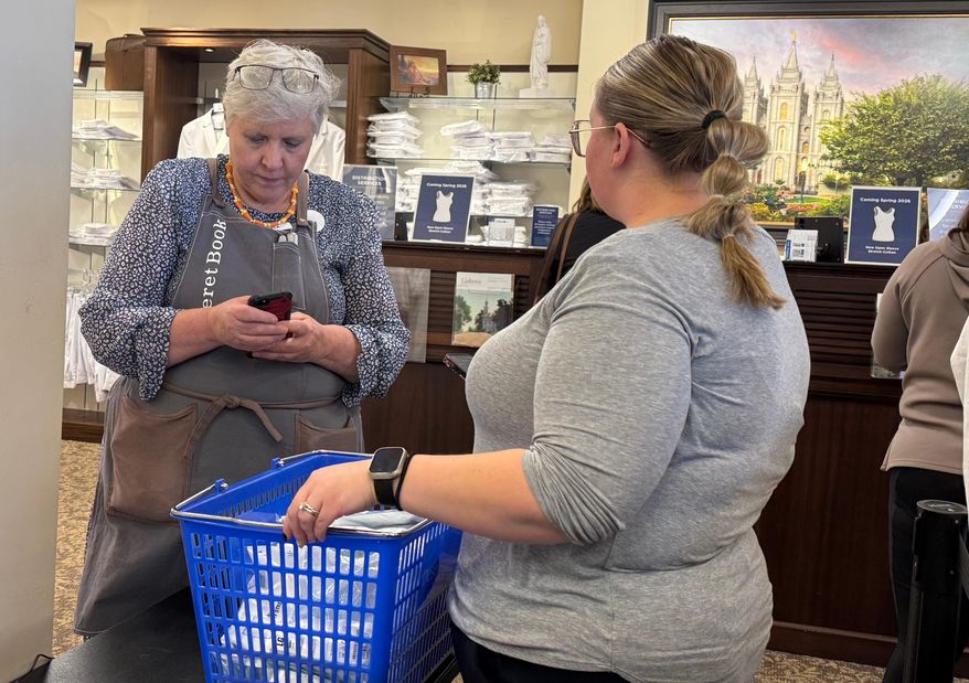 A woman shops for new sleeveless sacred garments worn by members of The Church of Jesus Christ of Latter-day Saints at Deseret Book in Salt Lake City on Tuesday, Oct. 28, 2025. (AP Photo/Hannah Schoenbaum)
