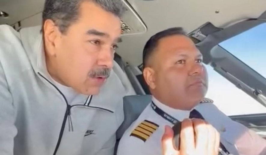 In this image made from a video posted on the Facebook account of Venezuelan President Nicolás Maduro on Dec. 15, 2023, Maduro stands behind pilot Gen. Bitner Villegas in the cockpit of an airplane. (AP Photo)