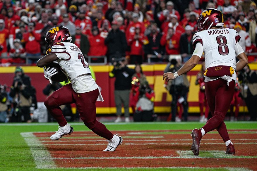 Washington Commanders running back Jacory Crosby-Merritt (22) takes the handoff from quarterback Marcus Mariota (8) in the end zone and gains two yards against the Kansas City Chiefs at GEHA Field at Arrowhead Stadium in Kansas City, Missouri, October 27, 2025. (Photo by Brian Murphy for the Washington Times)