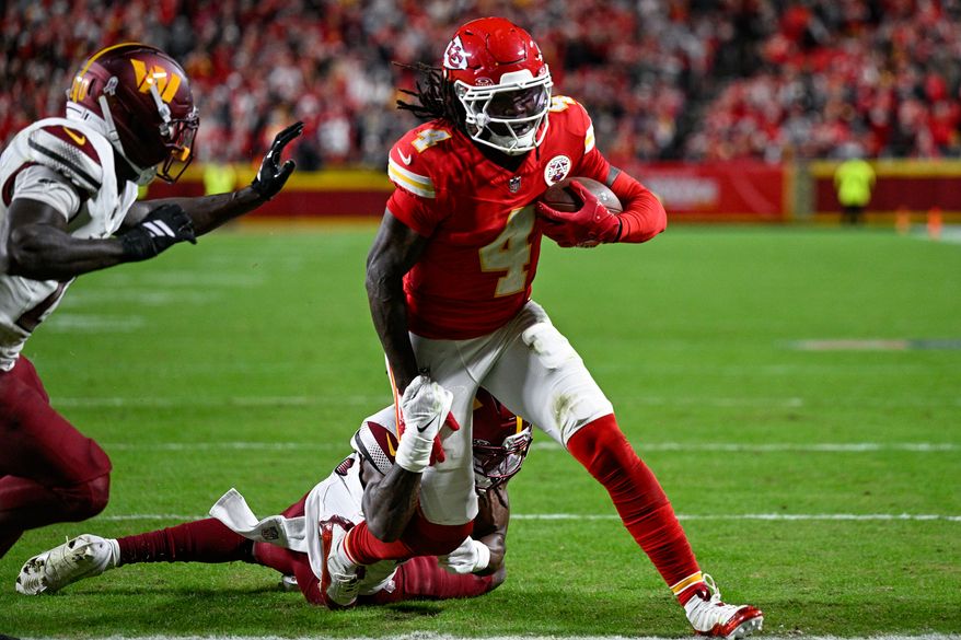 Kansas City Chiefs receiver Rashee Rice (4) drags a defender into the end zone on an 18-yard touchdown reception during the fourth quarter against the Kansas City Chiefs at GEHA Field at Arrowhead Stadium in Kansas City, Missouri, October 27, 2025. (Photo by Brian Murphy for the Washington Times)