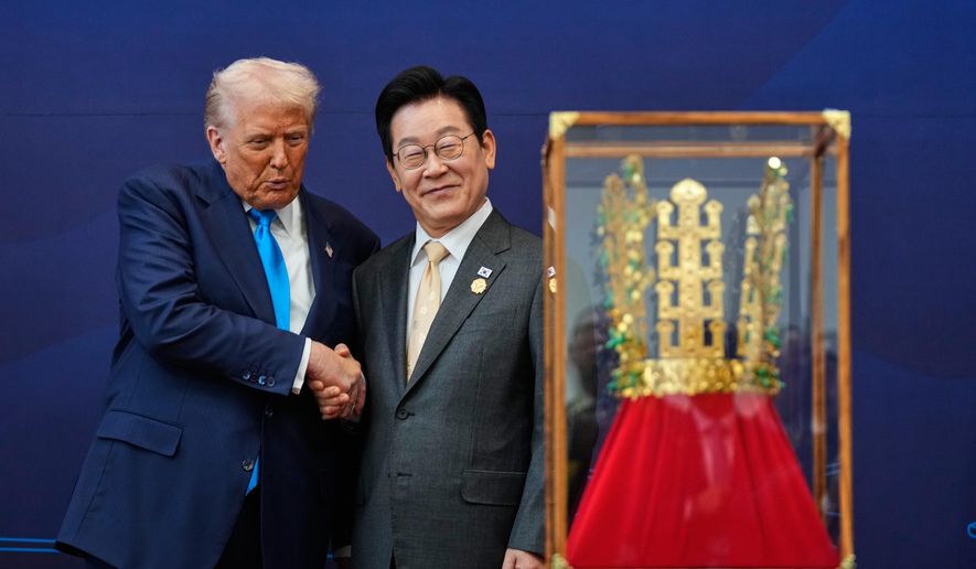 President Donald Trump shakes hands with South Korean President Lee Jae-myung as he receives a gift of a gold crown and an award of the Grand Order of Mugunghwa, not seen, during a high honor ceremony at the Gyeongju National Museum in Gyeongju, South Korea, Wednesday, Oct. 29, 2025. (AP Photo/Mark Schiefelbein)