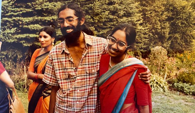 Tejaswini Rao chats with party guests while Subramanyam and Saraswathi Vedam embrace during their parents' wedding anniversary party at State College, Pa., in August 1981. (Saraswathi Vedam via AP)