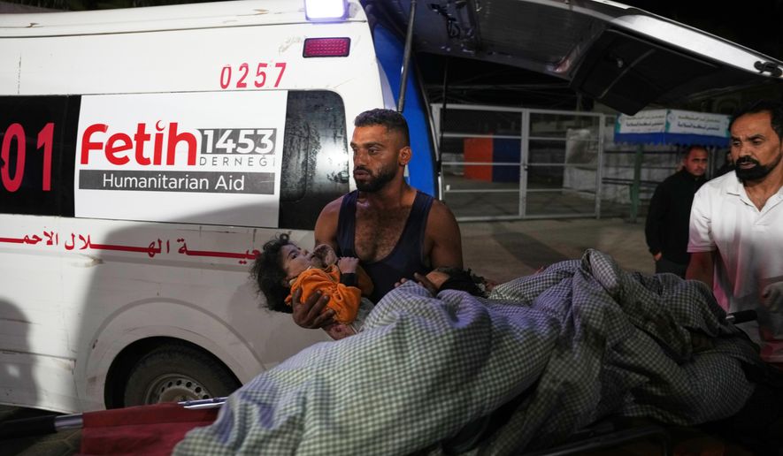 Palestinians injured in an Israeli army strike are brought to Al-Aqsa Hospital in Deir al-Balah, Gaza Strip, Wednesday, Oct. 29, 2025. (AP Photo/Abdel Kareem Hana)