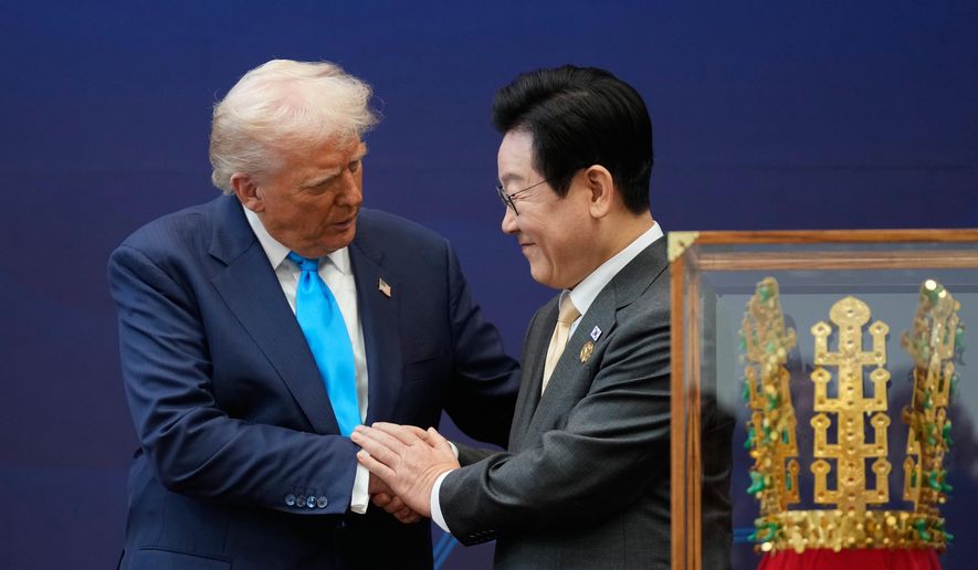 President Donald Trump shakes hands with South Korean President Lee Jae-myung as they attend a high honor ceremony at the Gyeongju National Museum in Gyoeongju, South Korea, Wednesday, Oct. 29, 2025. (AP Photo/Mark Schiefelbein)