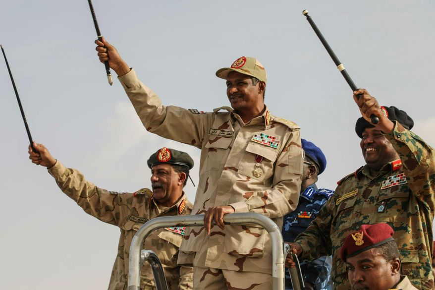 FILE.- Gen. Mohammed Hamdan Dagalo, centre, the deputy head of the military council, greets the crowd during a military-backed tribe's rally, in the Nile River State, Sudan, Saturday, July 13, 2019. (AP Photo/Mahmoud Hjaj,File)