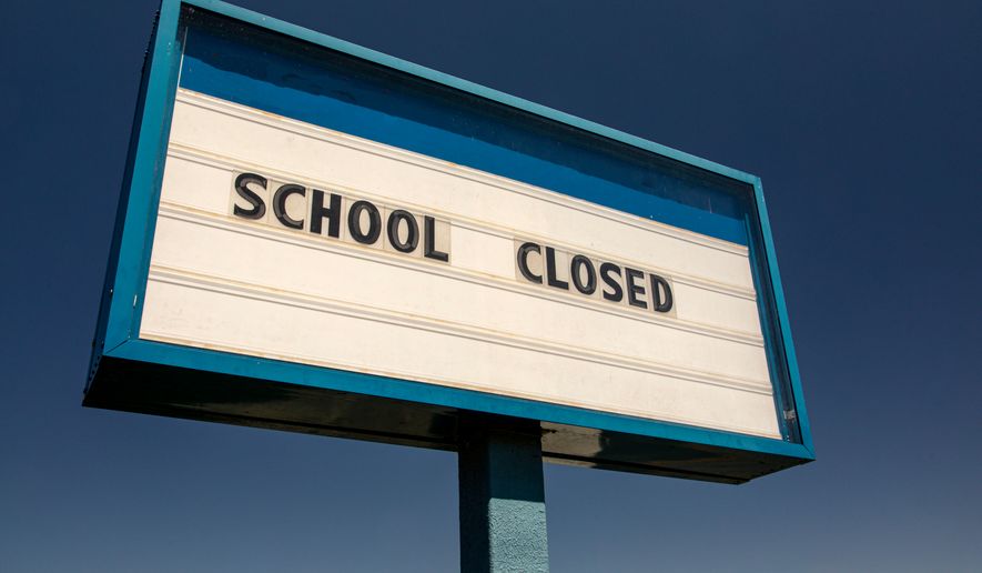 White sign with blue trim against blue sky stating School Closed. File photo credit: F Armstrong Photography via Shutterstock.