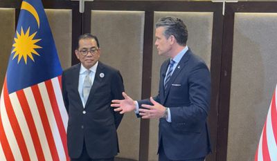 Defense Secretary Pete Hegseth (right) meets with Malaysian Defense Minister Mohamed Khaled bin Nordin and discusses deeper defense cooperation on Thursday, Oct. 30, 2025.(Bill Gertz/The Washington Times)