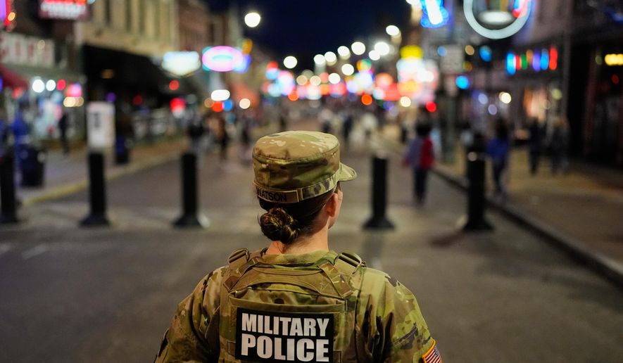 A member of the National Guard stands watch on Beale Street, Friday, Oct. 24, 2025, in Memphis, Tenn. (AP Photo/George Walker IV)