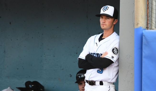 In this image provided by the Hudson Valley Renegades, Hudson Valley Renegades manager Blake Butera watches from the dugout during a minor league baseball game in Wappingers Falls, N.Y., in 2019. (Roy Notaro/Hudson Valley Renegades via AP) **FILE**