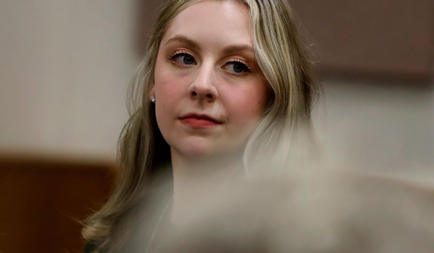 Former Richneck Elementary School teacher Abby Zwerner looks back into the courtroom during her civil lawsuit trial, Tuesday, Oct. 28, 2025, in Newport News, Va. (Stephen M. Katz/The Virginian-Pilot via AP, Pool)