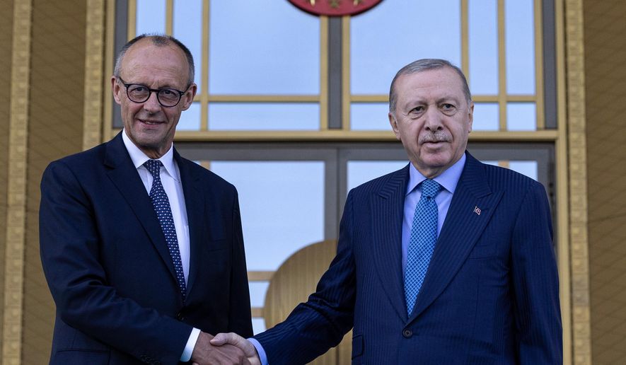 Turkey's President Recep Tayyip Erdogan, right, shakes hands with German Chancellor Friedrich Merz prior their meeting at the presidential palace in Ankara, Thursday, Oct. 30, 2025. (Ugur Yildirim/Dia Photo via AP)
