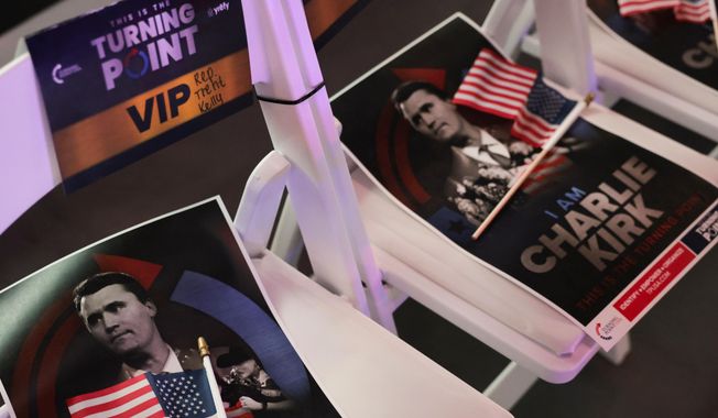 Signs with a photo of Charlie Kirk are seen before Vice President JD Vance speaks at a Turning Point USA event at the Pavilion at Ole Miss at the University of Mississippi in Oxford, Miss., Wednesday, Oct. 29, 2025. (Jonathan Ernst/Pool via AP)
