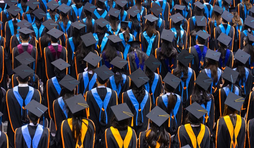 Graduates in a commencement ceremony. File photo credit: EduLife Photos via Shutterstock.