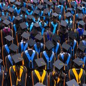 Graduates in a commencement ceremony. File photo credit: EduLife Photos via Shutterstock.