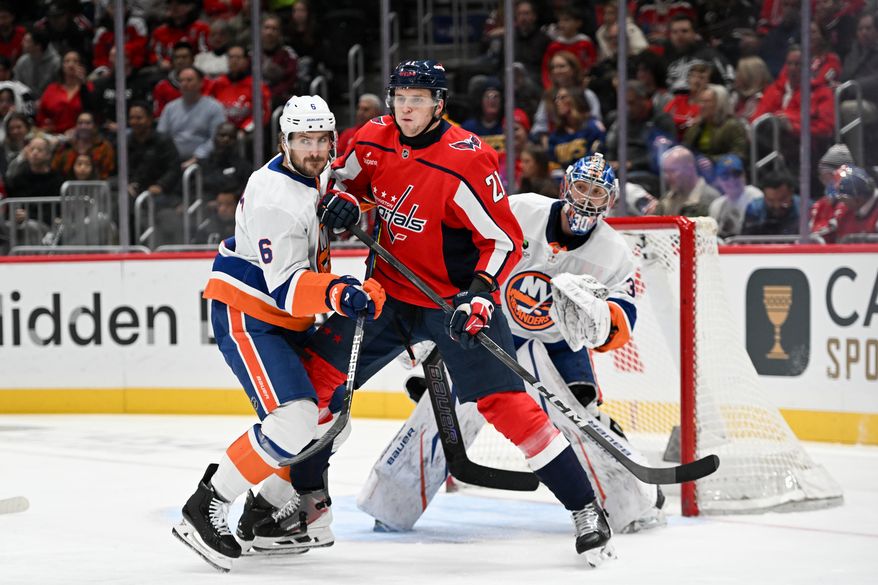 Washington Capitals center Alexei Protas (21) in front of the net between New York Islanders defenseman Ryan Pulock (6) and goalie Ilya Sorokin (30) during the first period of an NHL game at Capital One Arena in Washington D.C., October 31, 2025. (Photo for the Washington Times)