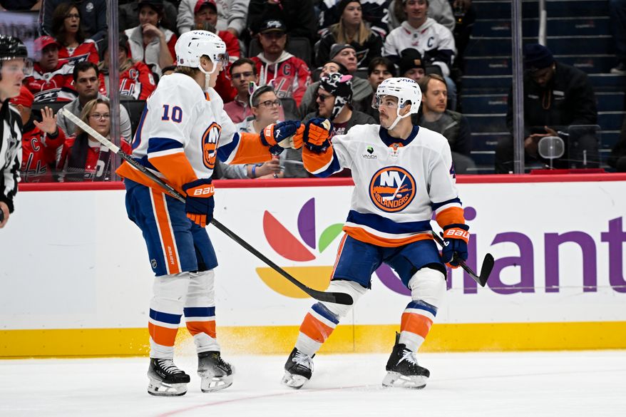 New York Islanders center Jean-Gabriel Pageau (44) celebrating with teammate forward Simon Holmstrom (10) after scoring a short-handed goal during the second period of an NHL game against the Washington Capitals at Capital One Arena in Washington D.C., October 31, 2025. (Photo for the Washington Times)