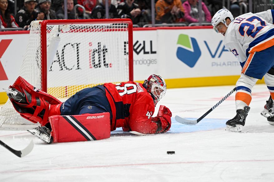 Washington Capitals goalie Logan Thompson (48) making a diving save on a shot by New York Islanders forward Anders Lee (27)bduring the third period of an NHL game at Capital One Arena in Washington D.C., October 31, 2025. (Photo for the Washington Times)