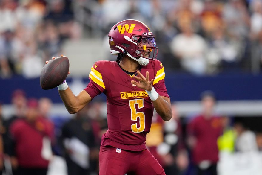 Washington Commanders quarterback Jayden Daniels (5) looks to pass against the Dallas Cowboys during the first half of an NFL football game Sunday, Oct. 19, 2025, in Arlington, Texas. (AP Photo/Jeffrey McWhorter)