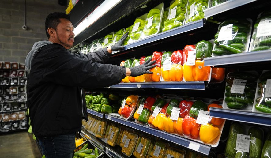 A grocery store employee stocks produce, which is covered by the USDA Supplemental Nutrition Assistance Program (SNAP), at a grocery store in Baltimore, Thursday, Oct. 30, 2025. (AP Photo/Stephanie Scarbrough)