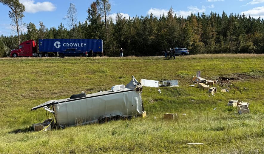 This photo provided by Scotty Ray Boyd shows an overturned truck which had been transporting several monkeys, Tuesday, Oct. 28, 2025, in Heidelberg, Miss. (Scotty Ray Boyd via AP)