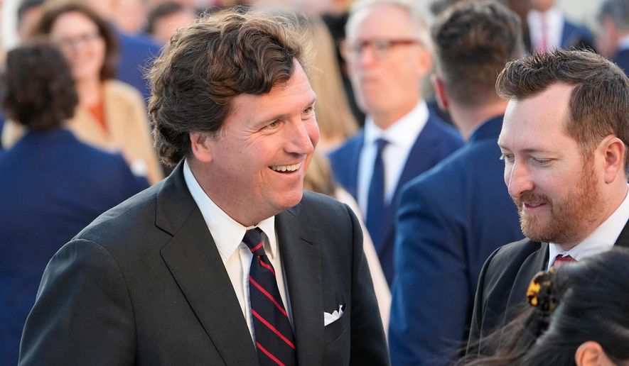 Tucker Carlson talks after President Donald Trump posthumously awarded the Presidential Medal of Freedom to Charlie Kirk in the Rose Garden of the White House, Tuesday, Oct. 14, 2025, in Washington. (AP Photo/Alex Brandon)