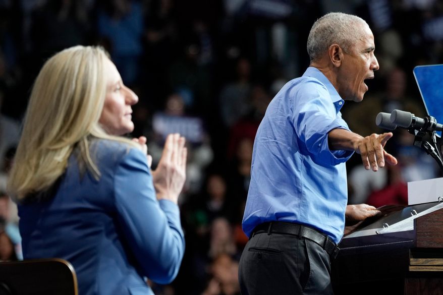 Former President Barack Obama, gestures during a rally for Virginia Democratic gubernatorial candidate Abigail Spanberger, left, Saturday, Nov. 1, 2025, in Norfolk, Va. (AP Photo/Steve Helber)